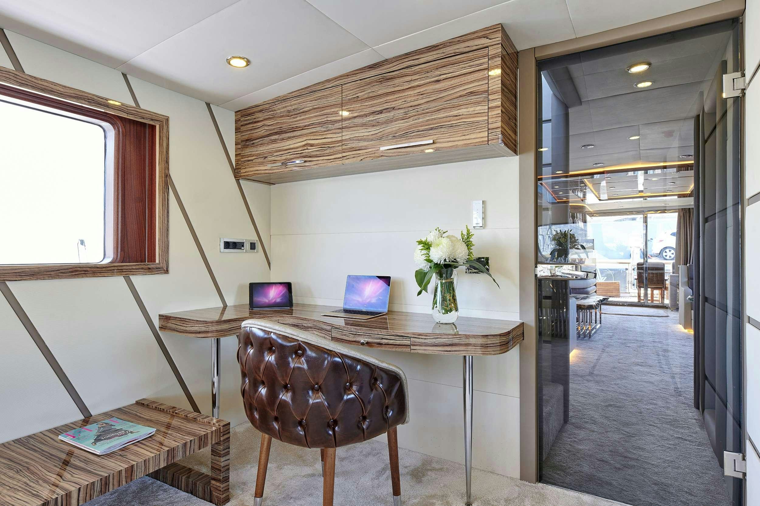 a room with a table and chairs aboard WIDE LIBERTY Yacht for Charter