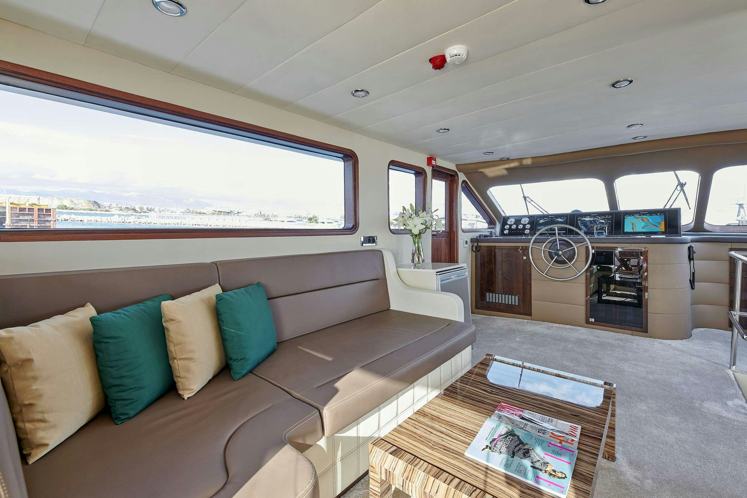 a living room with a couch and a tv aboard WIDE LIBERTY Yacht for Charter