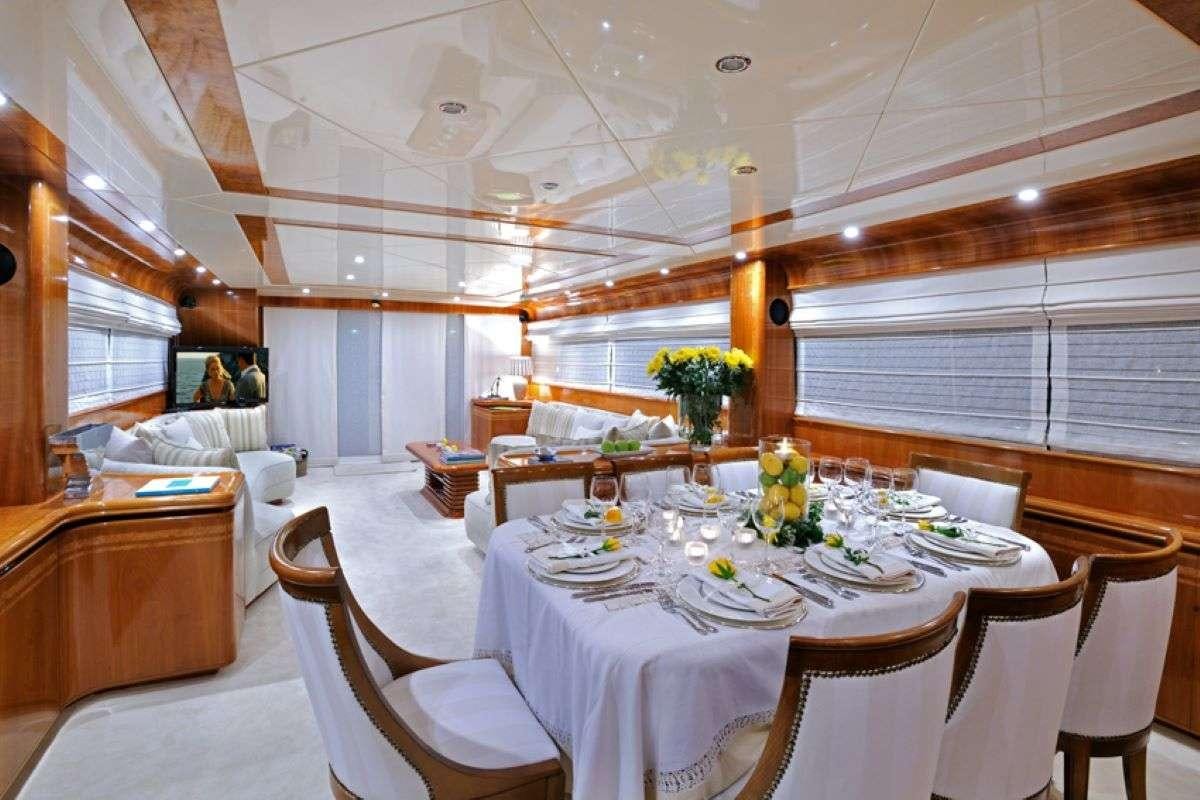 a room with tables and chairs aboard BLU SKY Yacht for Charter