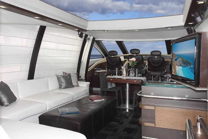 a room with a couch and a television aboard SUPER TOY Yacht for Charter