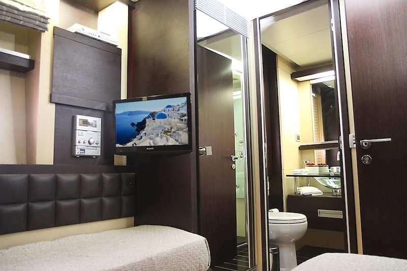 a room with a couch and a bed aboard SUPER TOY Yacht for Charter