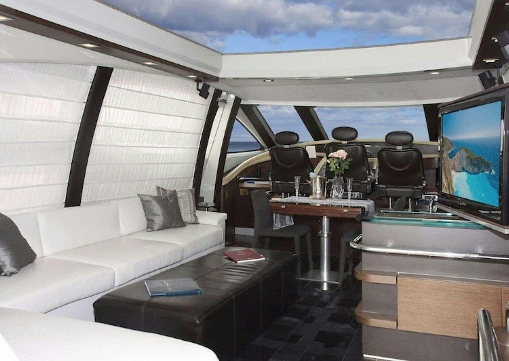 a room with a couch and a television aboard SUPER TOY Yacht for Charter