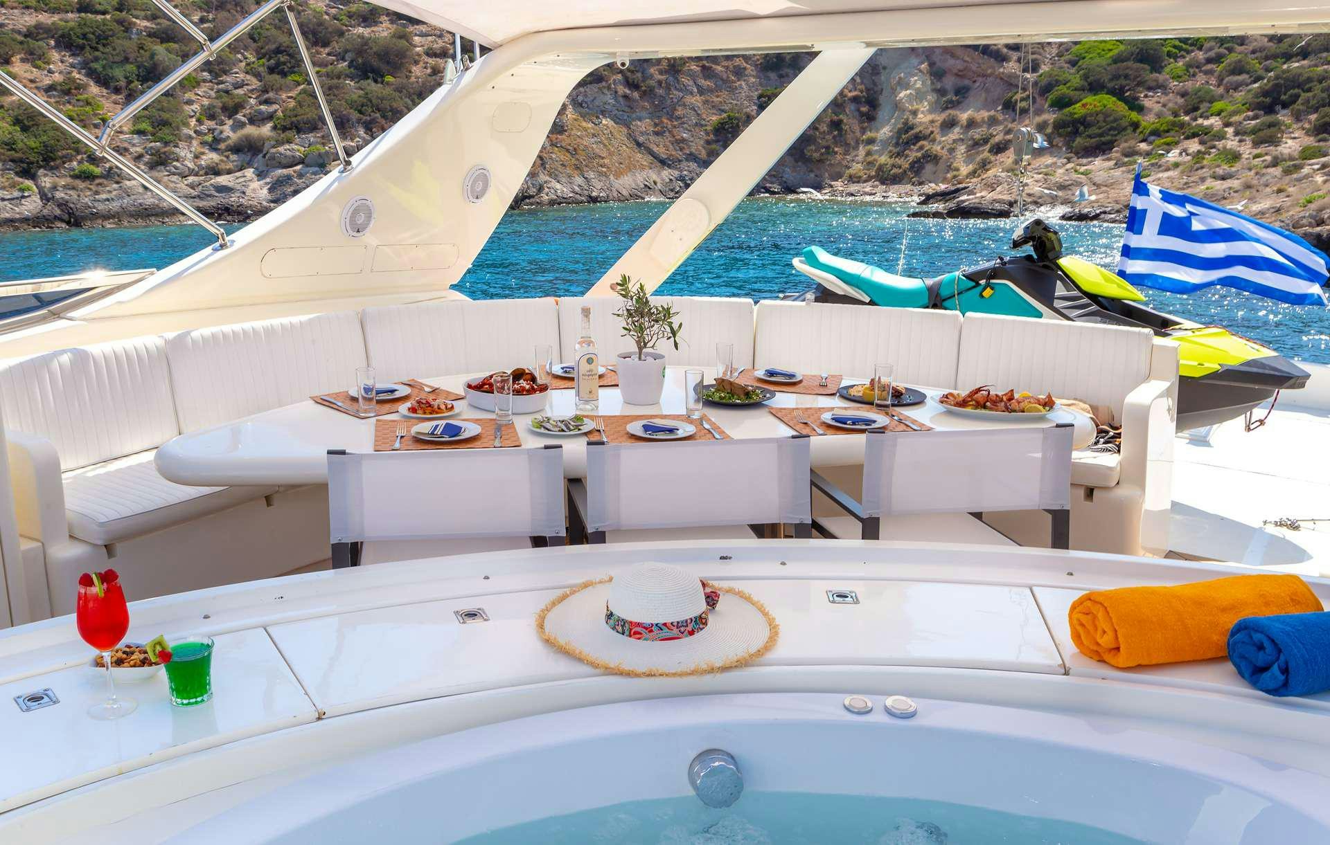 a pool with a table and chairs aboard EFMARIA Yacht for Charter