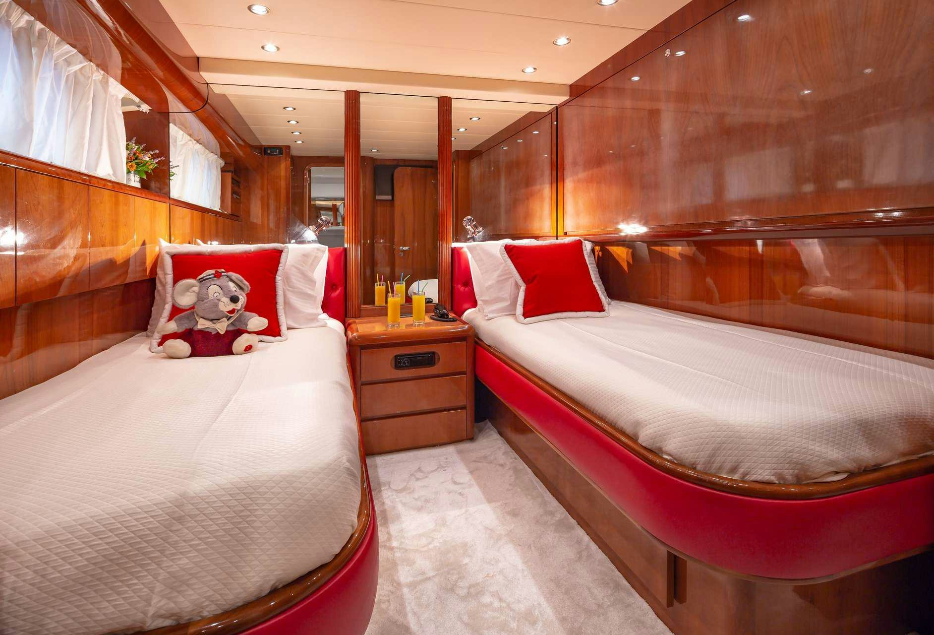 a room with beds and a wood wall aboard EFMARIA Yacht for Charter