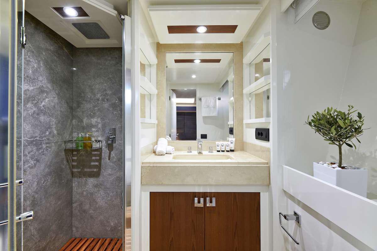a bathroom with a shower unit and sink aboard LA FENICE Yacht for Charter