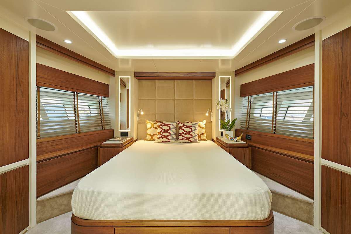 a bedroom with a bed and a window aboard LA FENICE Yacht for Charter