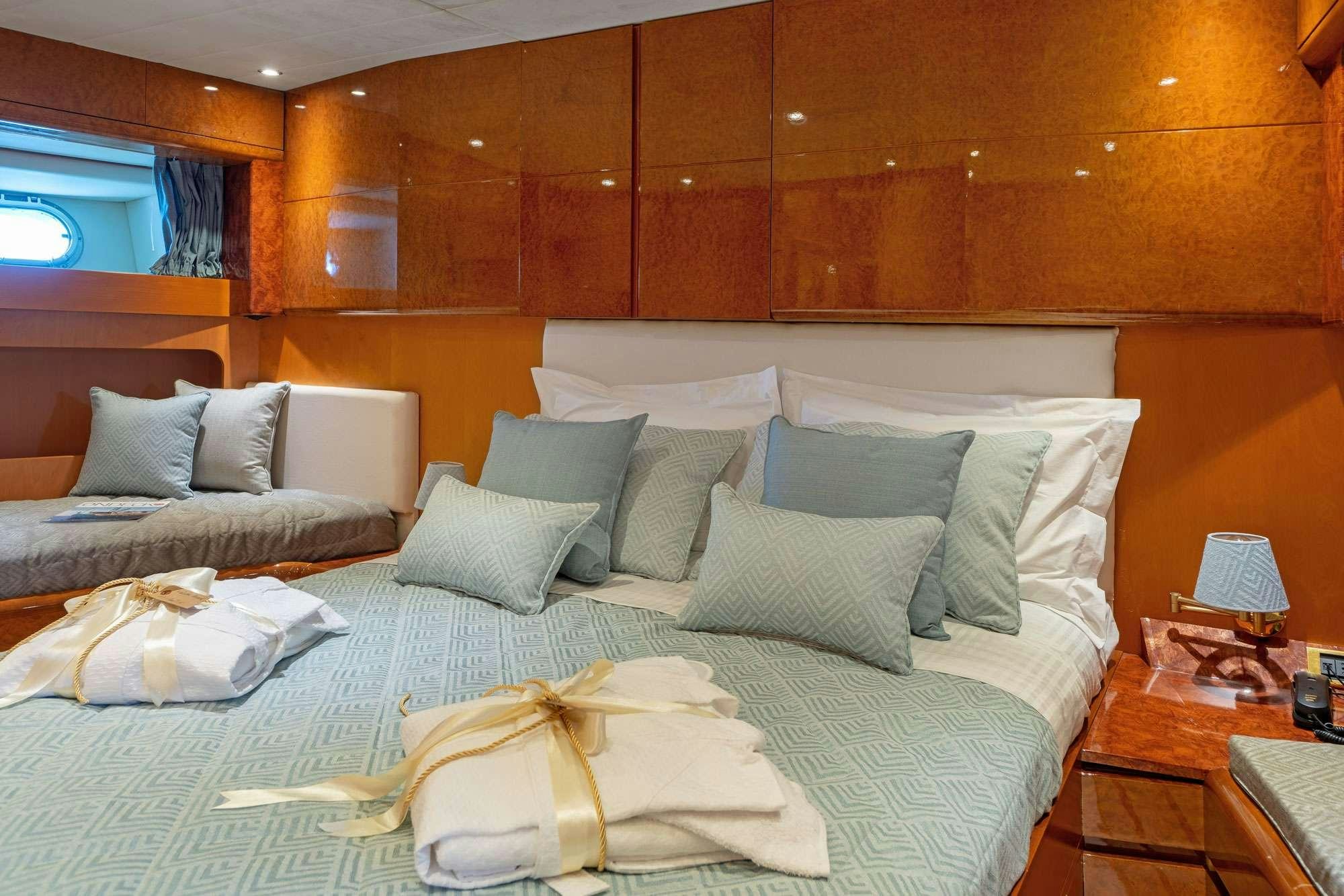a bed with white pillows aboard ALANDINI Yacht for Charter