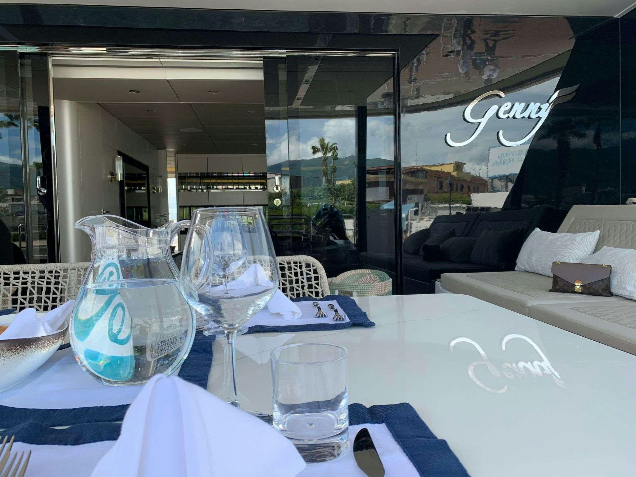 a table with glasses and napkins aboard GENNY Yacht for Charter