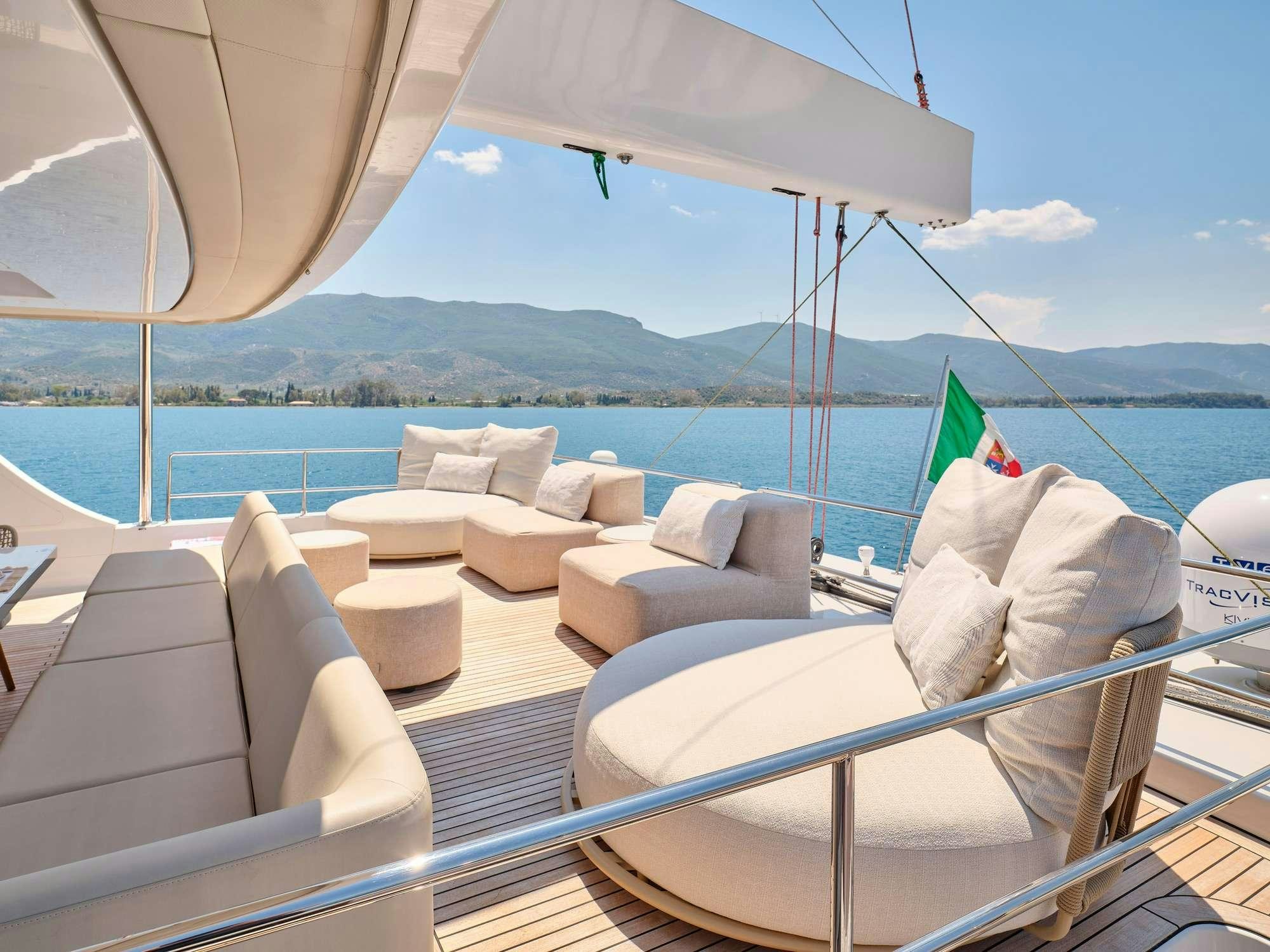 a boat with a couch and a chair on it aboard GENNY Yacht for Charter