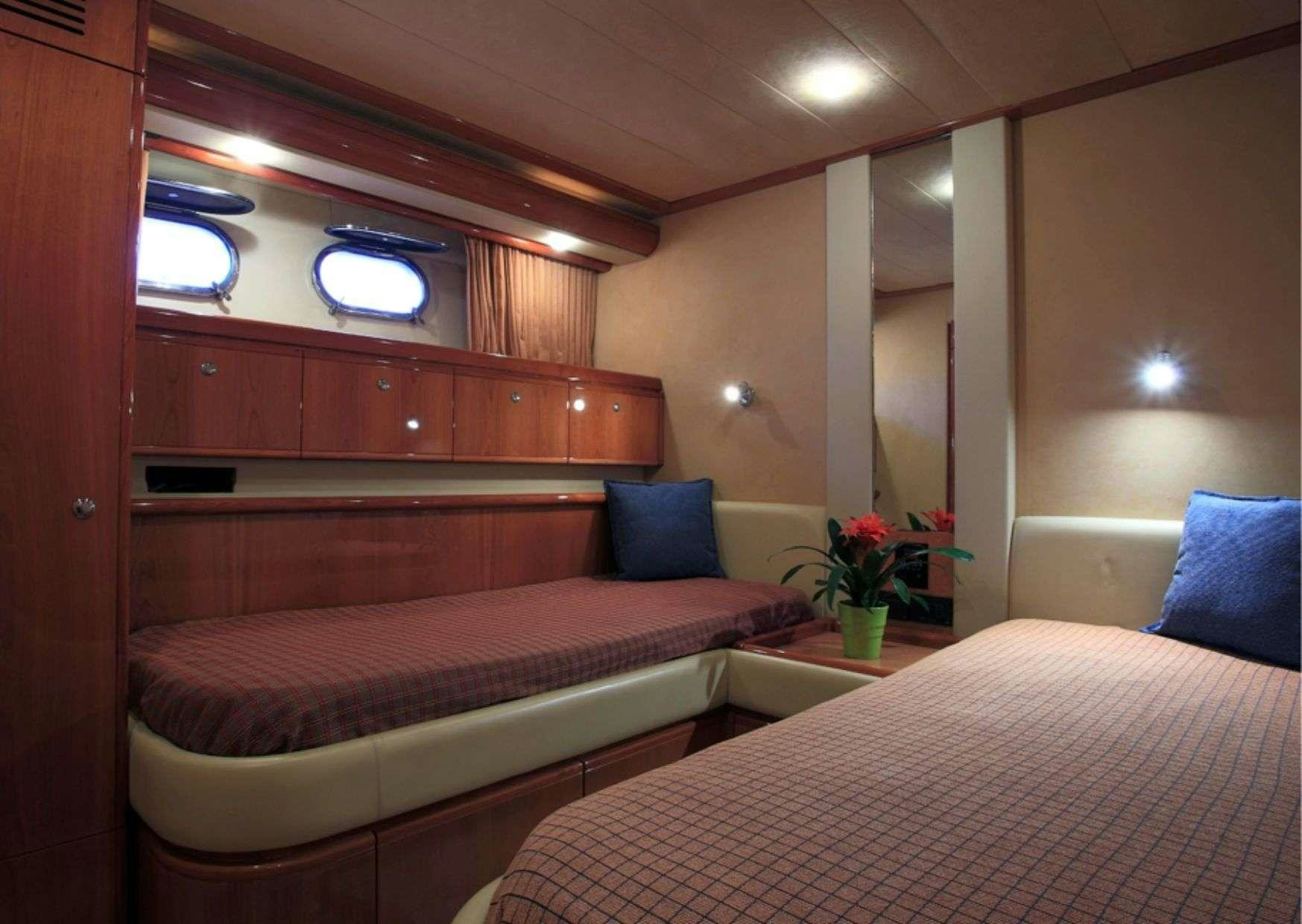 a room with two beds aboard ADE YIA Yacht for Charter