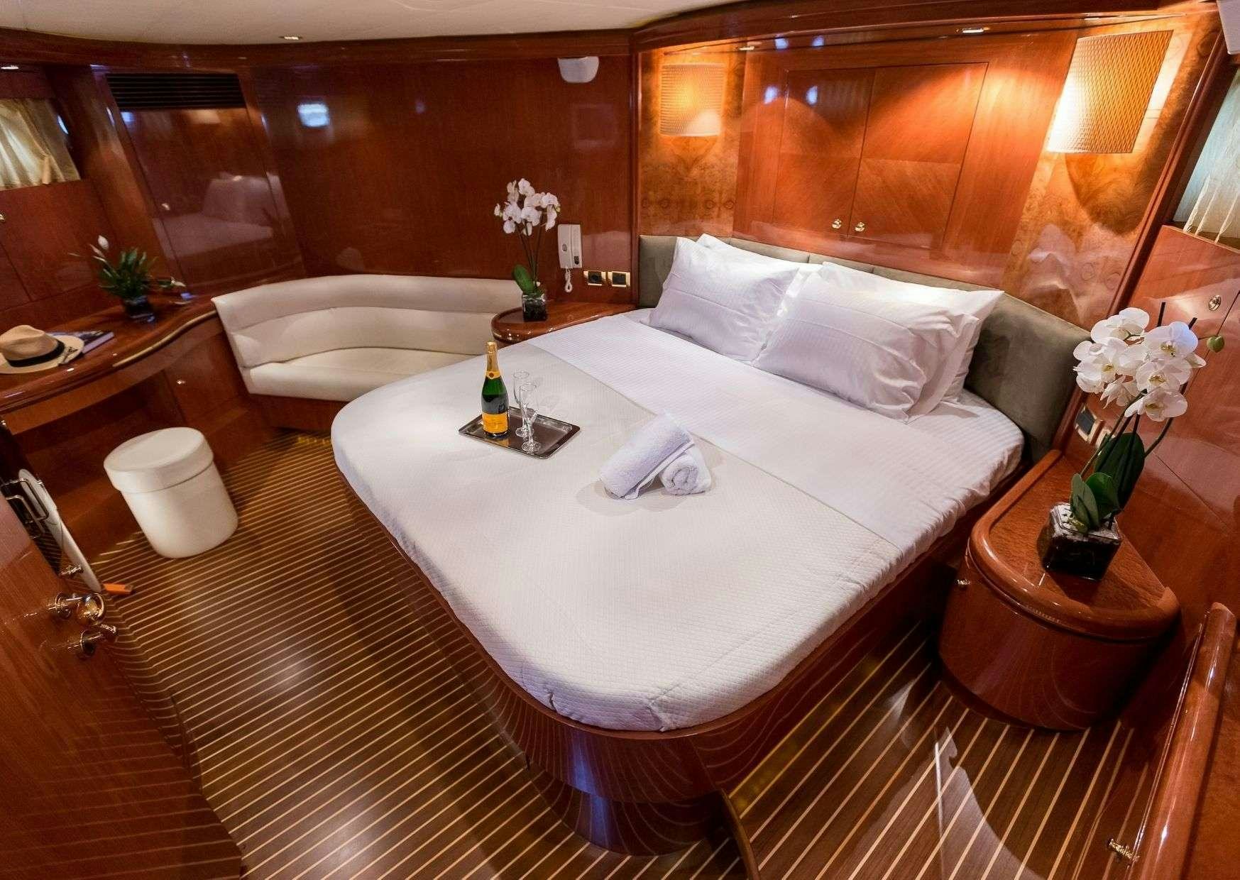 a room with a bed and a table aboard MARLIN Yacht for Charter