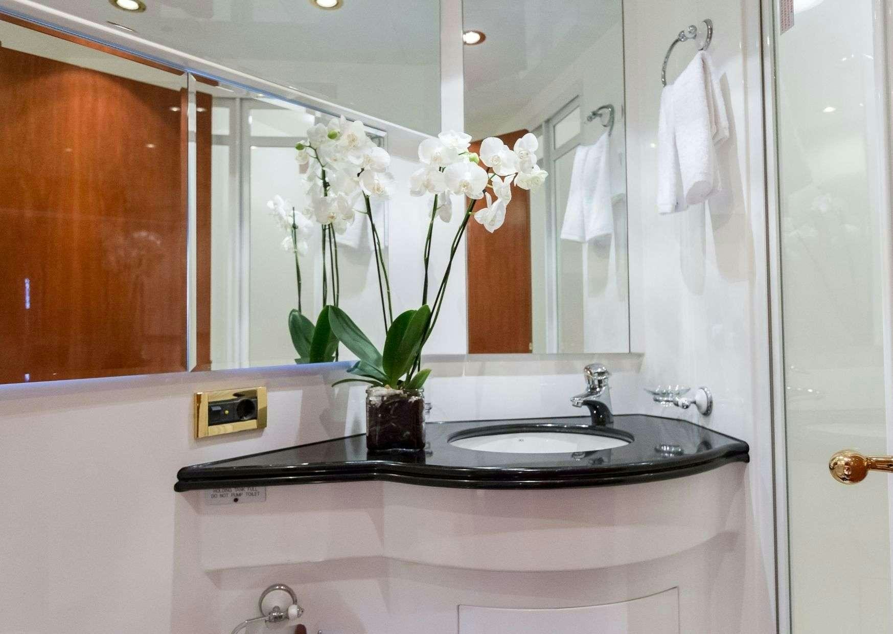 a bathroom sink with flowers aboard MARLIN Yacht for Charter