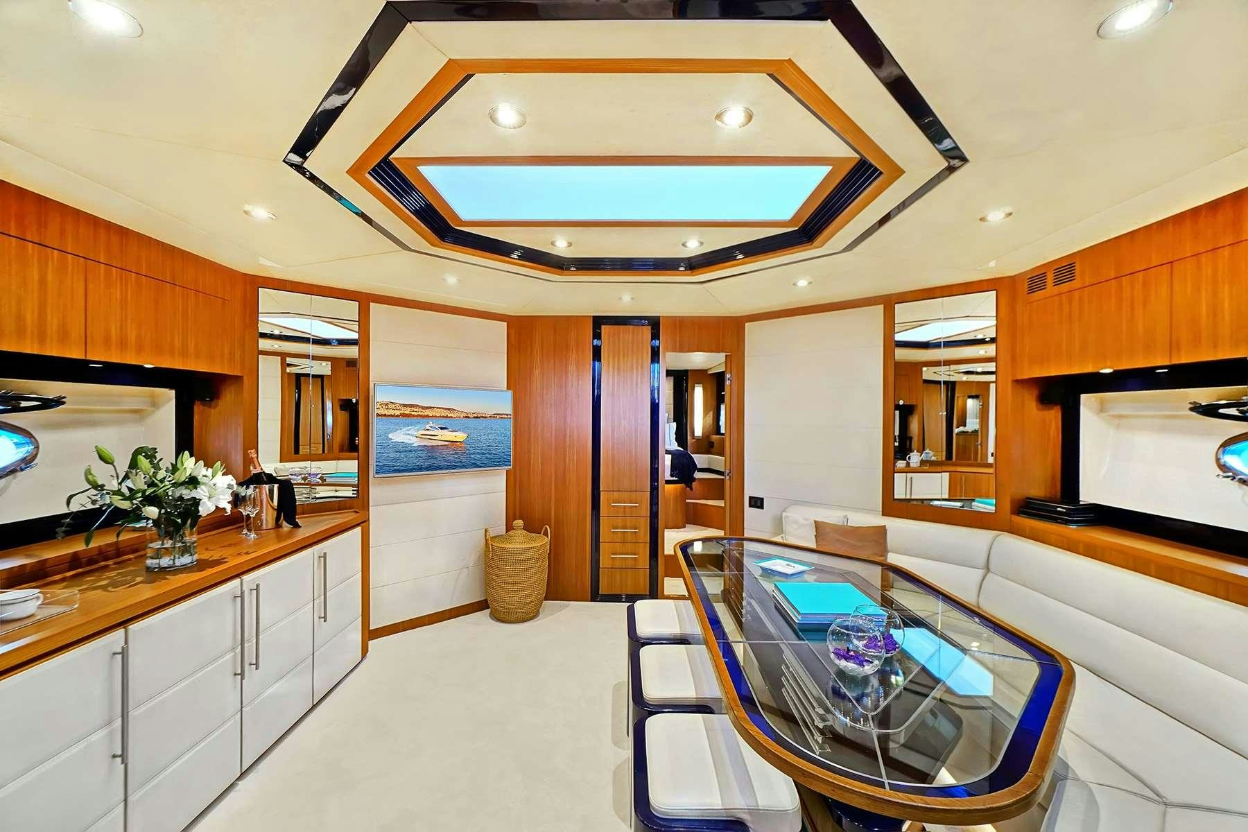 a large kitchen with a dining table aboard SEA U Yacht for Charter