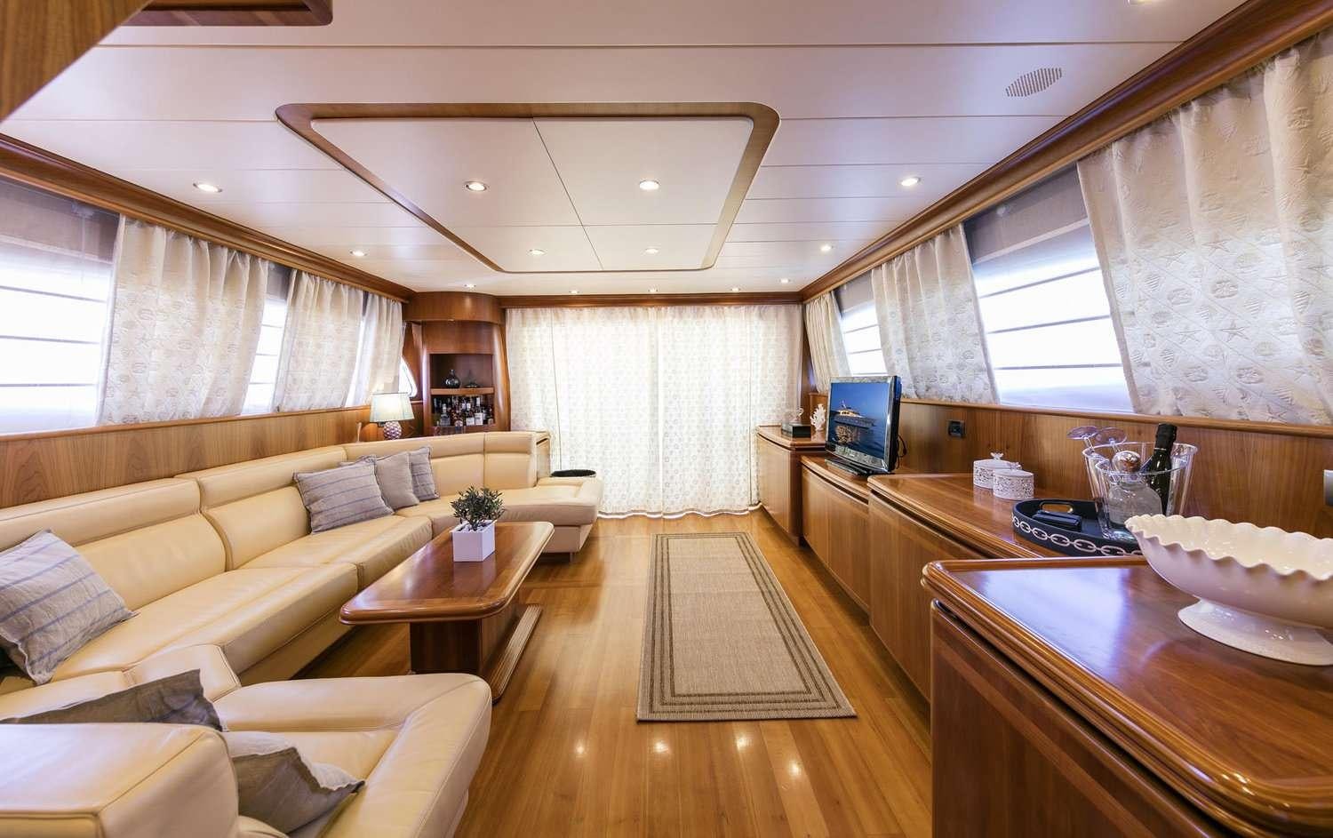 a living room with a wood floor aboard GORGEOUS Yacht for Charter