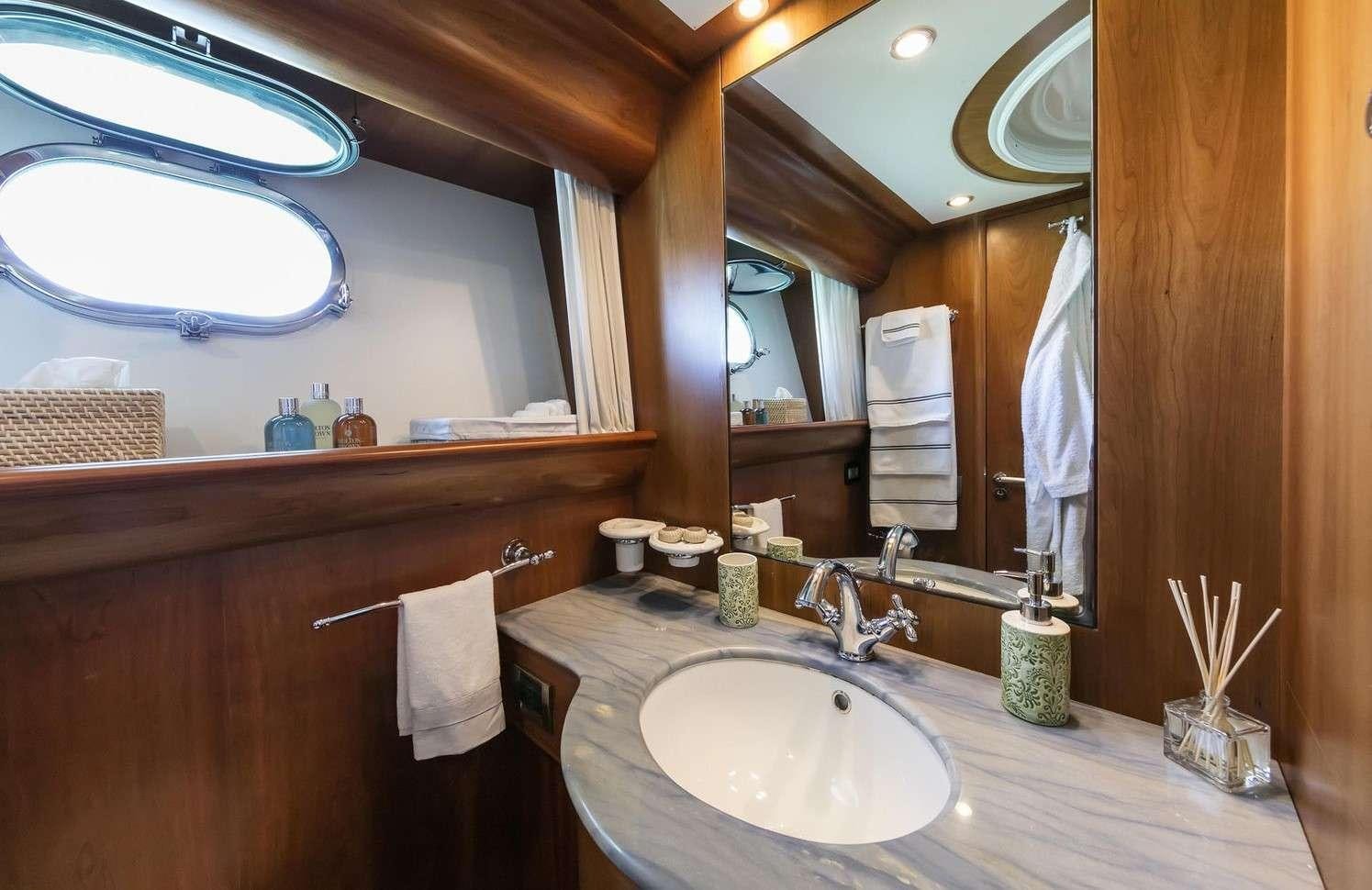 a bathroom with a sink and a mirror aboard GORGEOUS Yacht for Charter