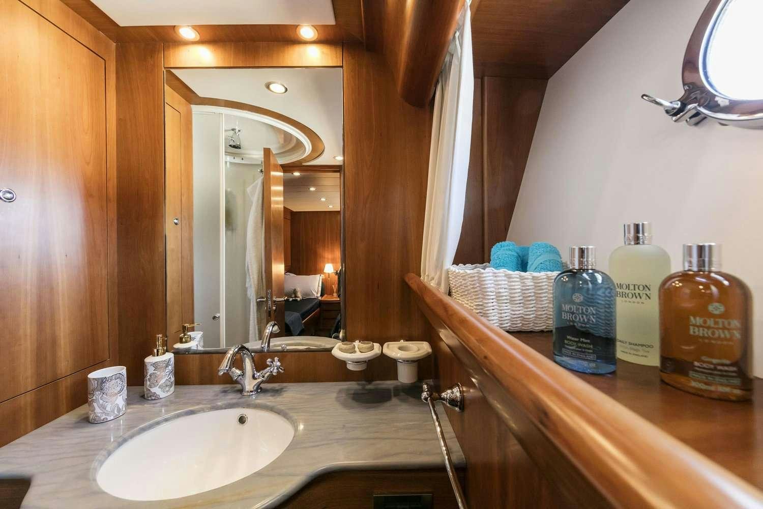 a bathroom with a sink and a mirror aboard GORGEOUS Yacht for Charter