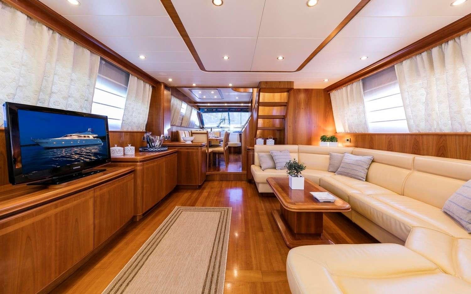 a living room with a large screen aboard GORGEOUS Yacht for Charter