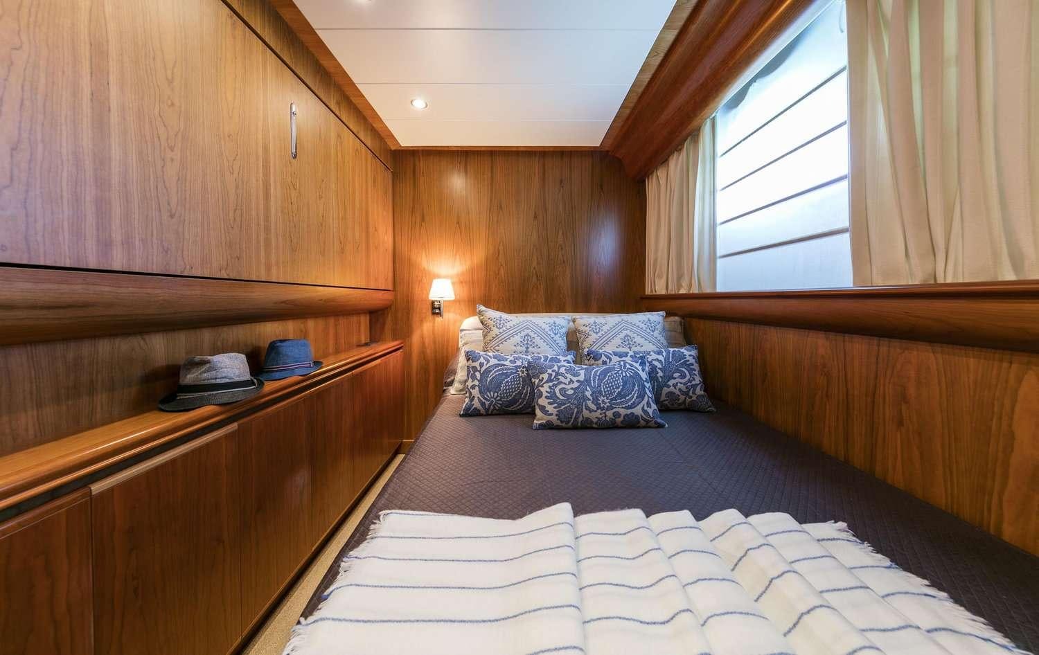 a bed with a white sheet aboard GORGEOUS Yacht for Charter