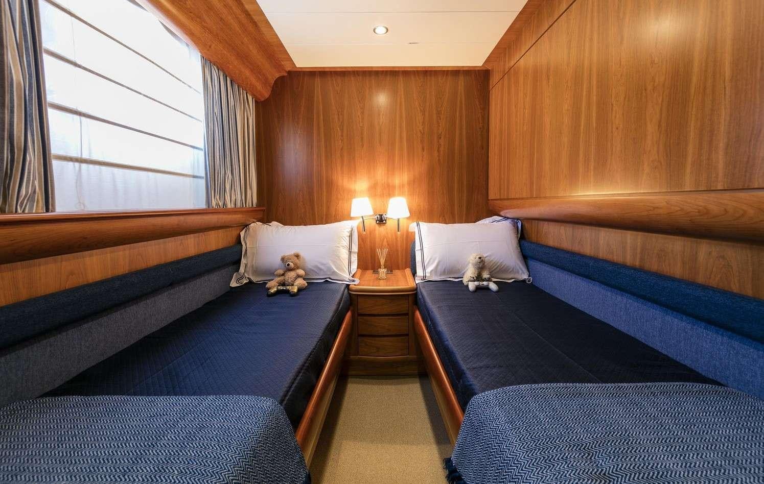 a couple of beds in a room aboard GORGEOUS Yacht for Charter