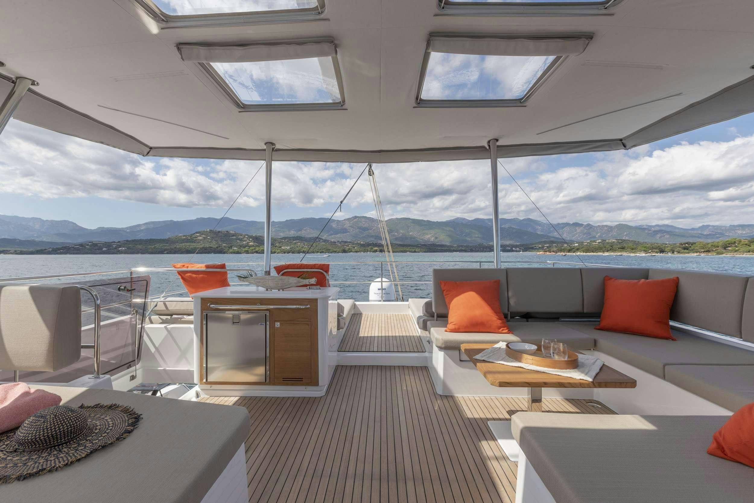 a room with a couch and a table and chairs aboard KIMATA Yacht for Charter