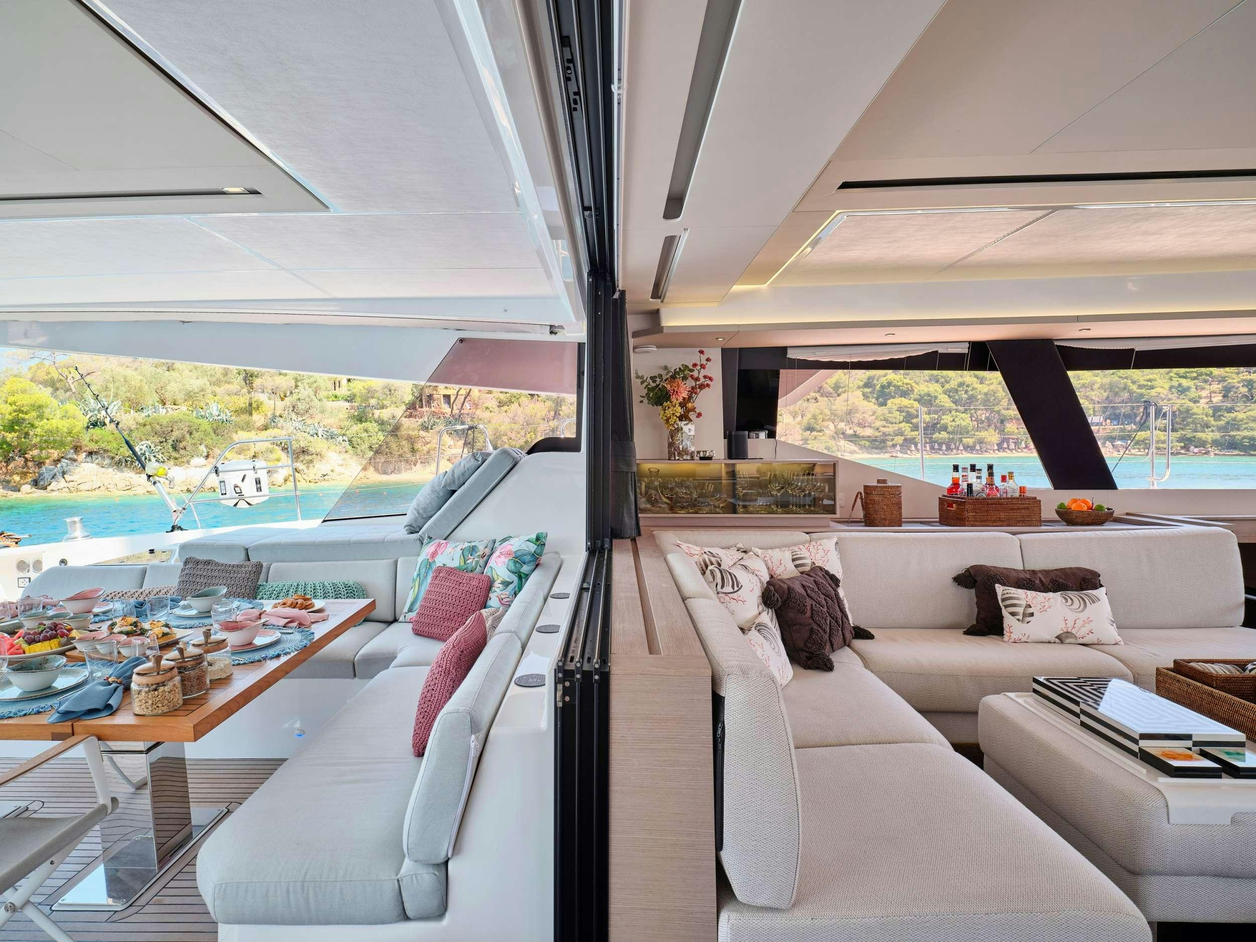 a living room with a large window aboard KIMATA Yacht for Charter