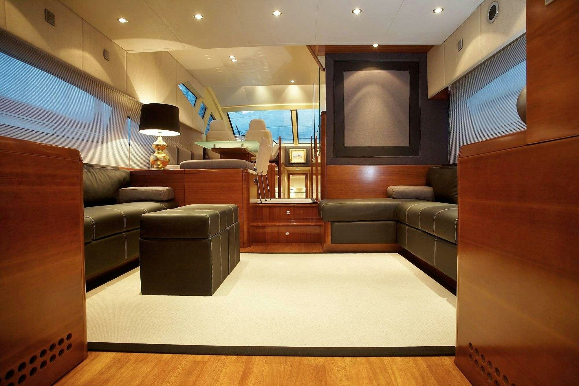 a living room with leather couches aboard REVIVAL Yacht for Charter