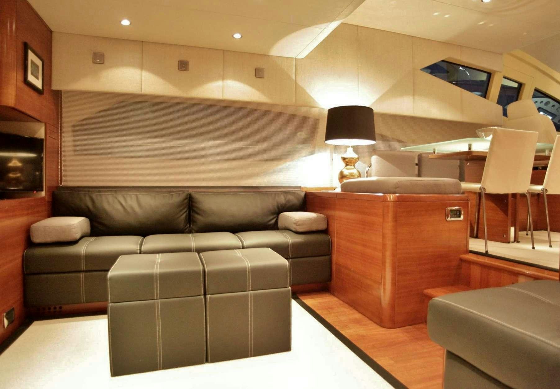 a living room with a couch and a fireplace aboard REVIVAL Yacht for Charter