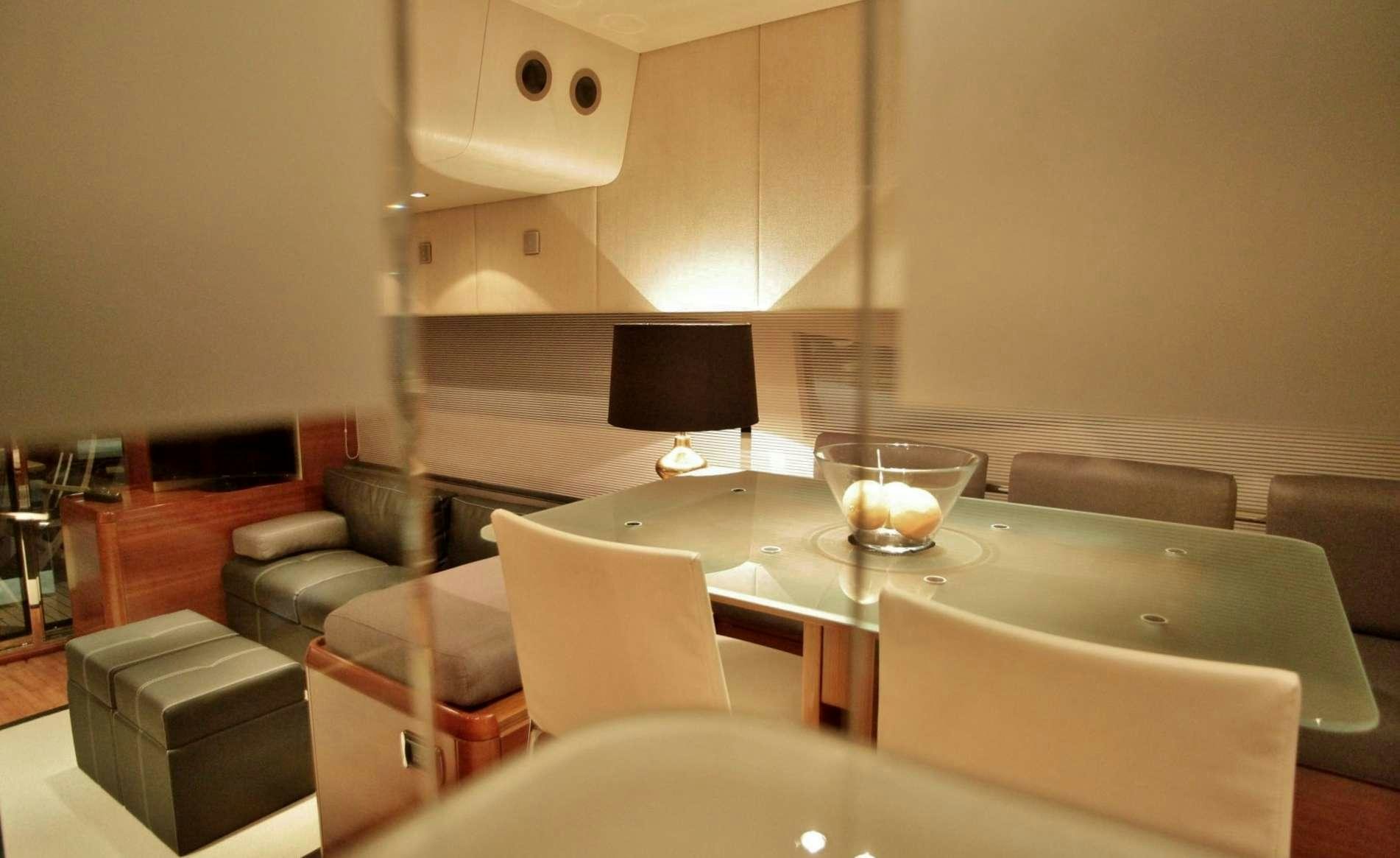 a room with a table and chairs aboard REVIVAL Yacht for Charter