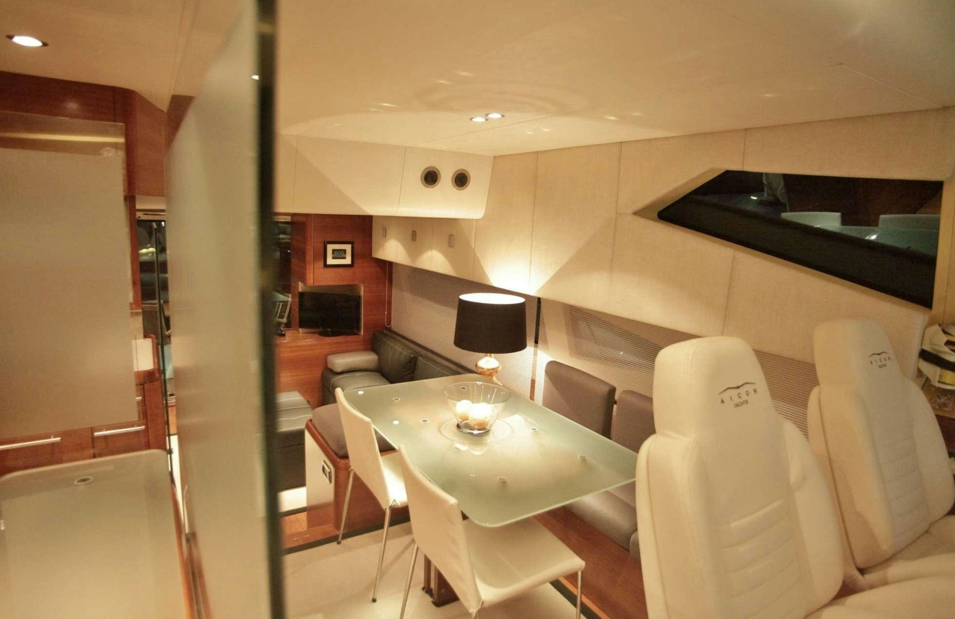 a table and chairs in a room aboard REVIVAL Yacht for Charter