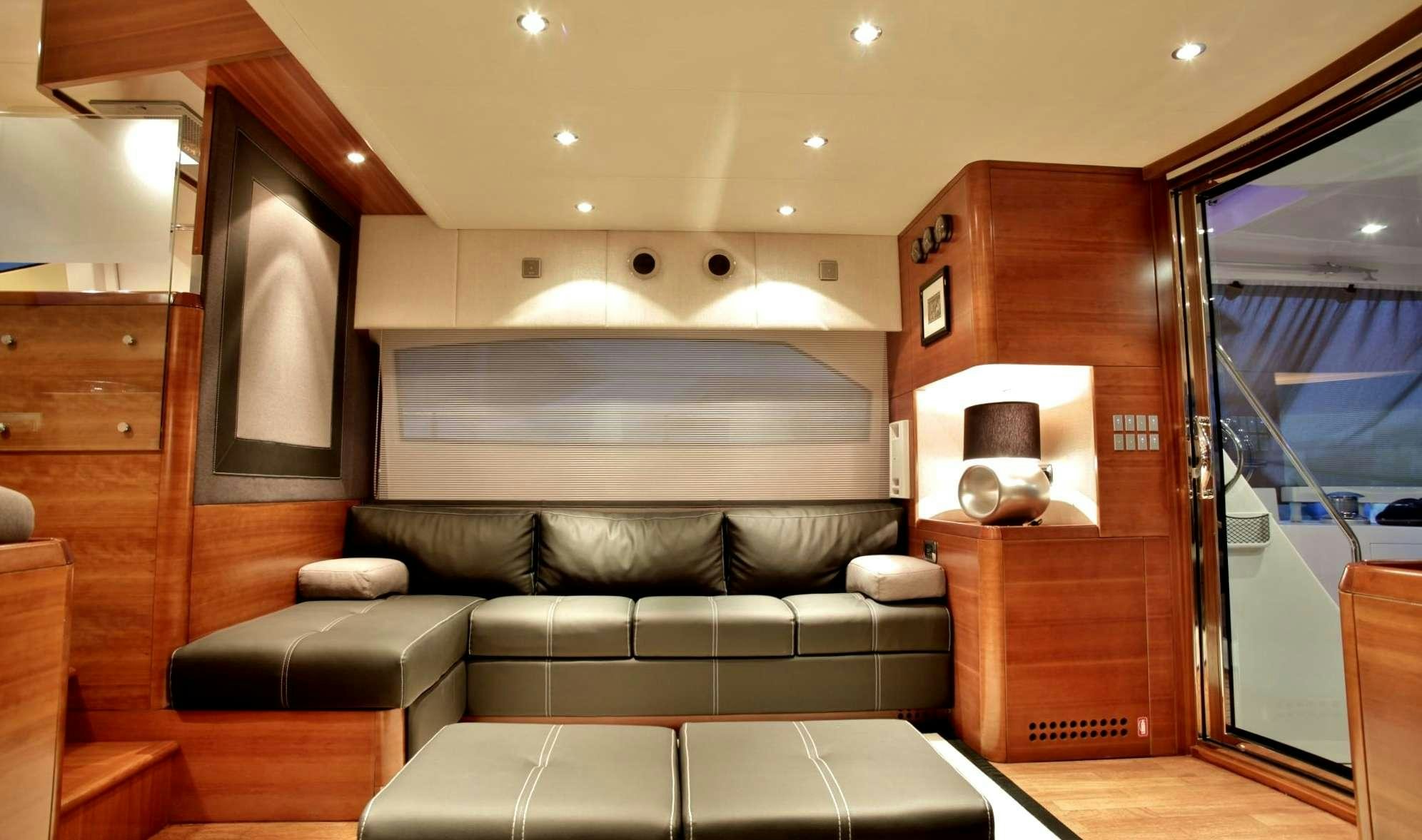 a living room with a leather couch aboard REVIVAL Yacht for Charter
