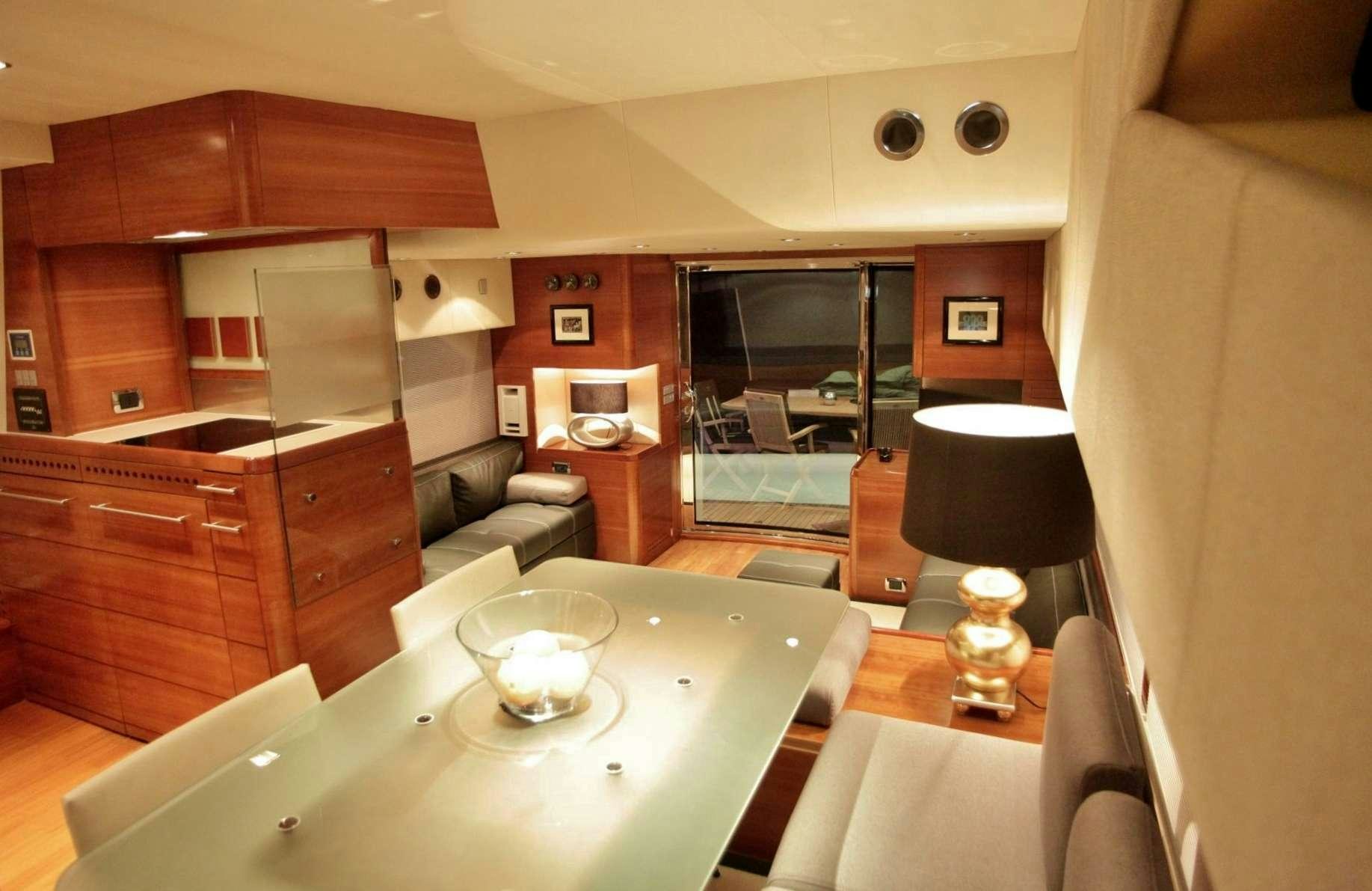 a kitchen with a table and chairs aboard REVIVAL Yacht for Charter