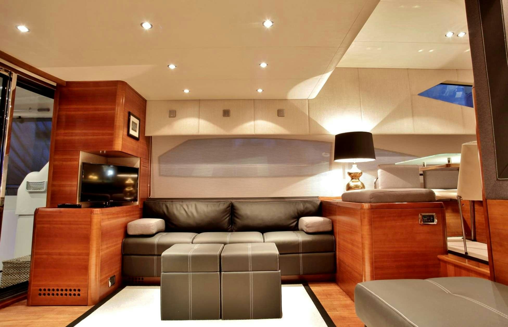 a living room with a couch and a tv aboard REVIVAL Yacht for Charter