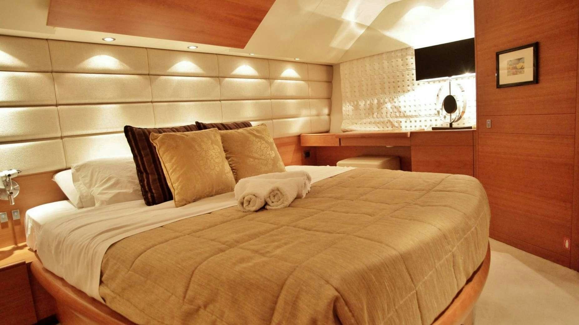 a bed with pillows aboard REVIVAL Yacht for Charter