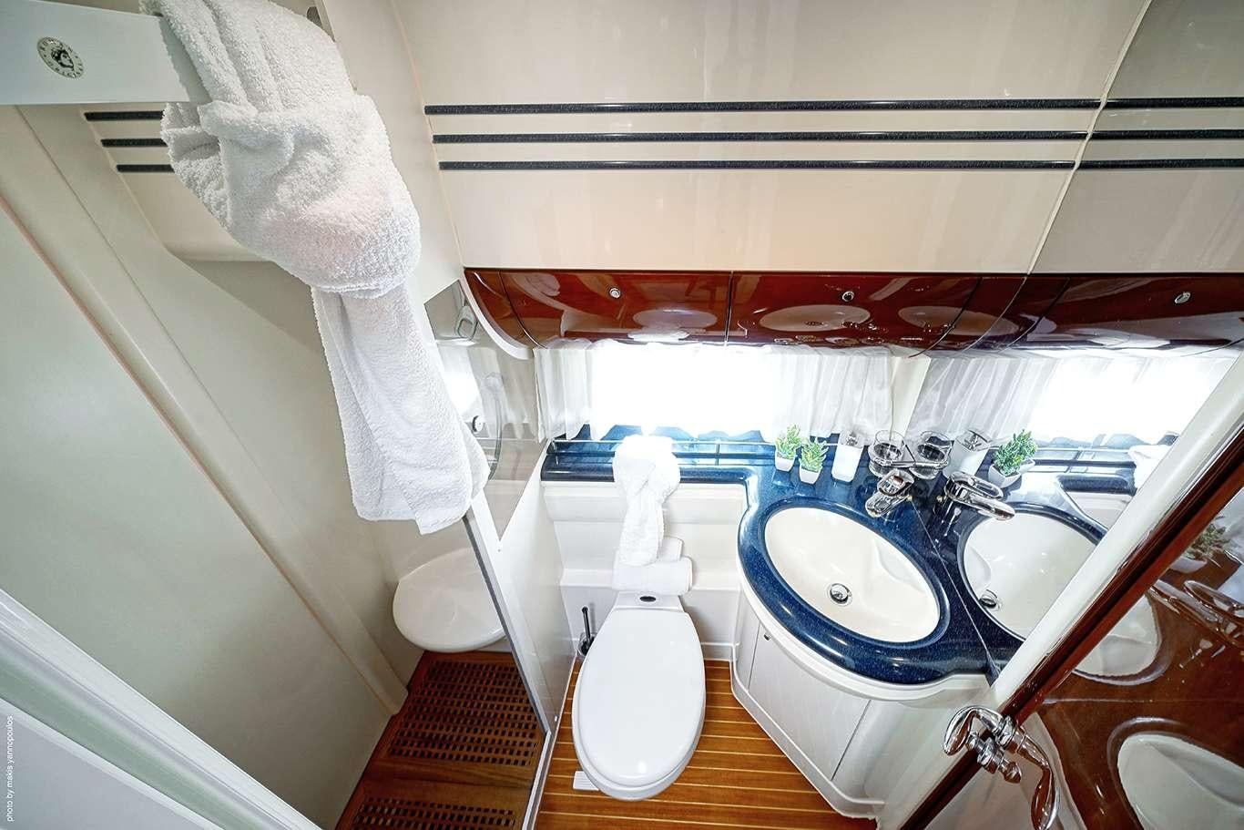a bathroom with a tub sink and toilet aboard DISTAR PRINCESS Yacht for Charter
