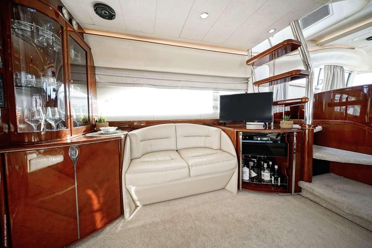 a living room with a couch and a tv aboard DISTAR PRINCESS Yacht for Charter