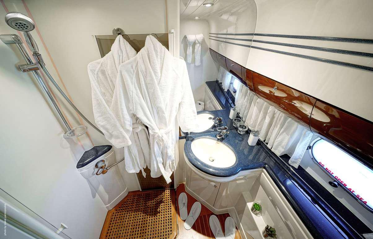 a bathroom with a sink and a mirror aboard DISTAR PRINCESS Yacht for Charter