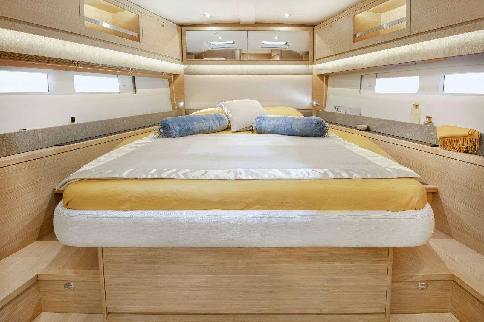 a room with a bed and a desk aboard DIMPA Yacht for Charter