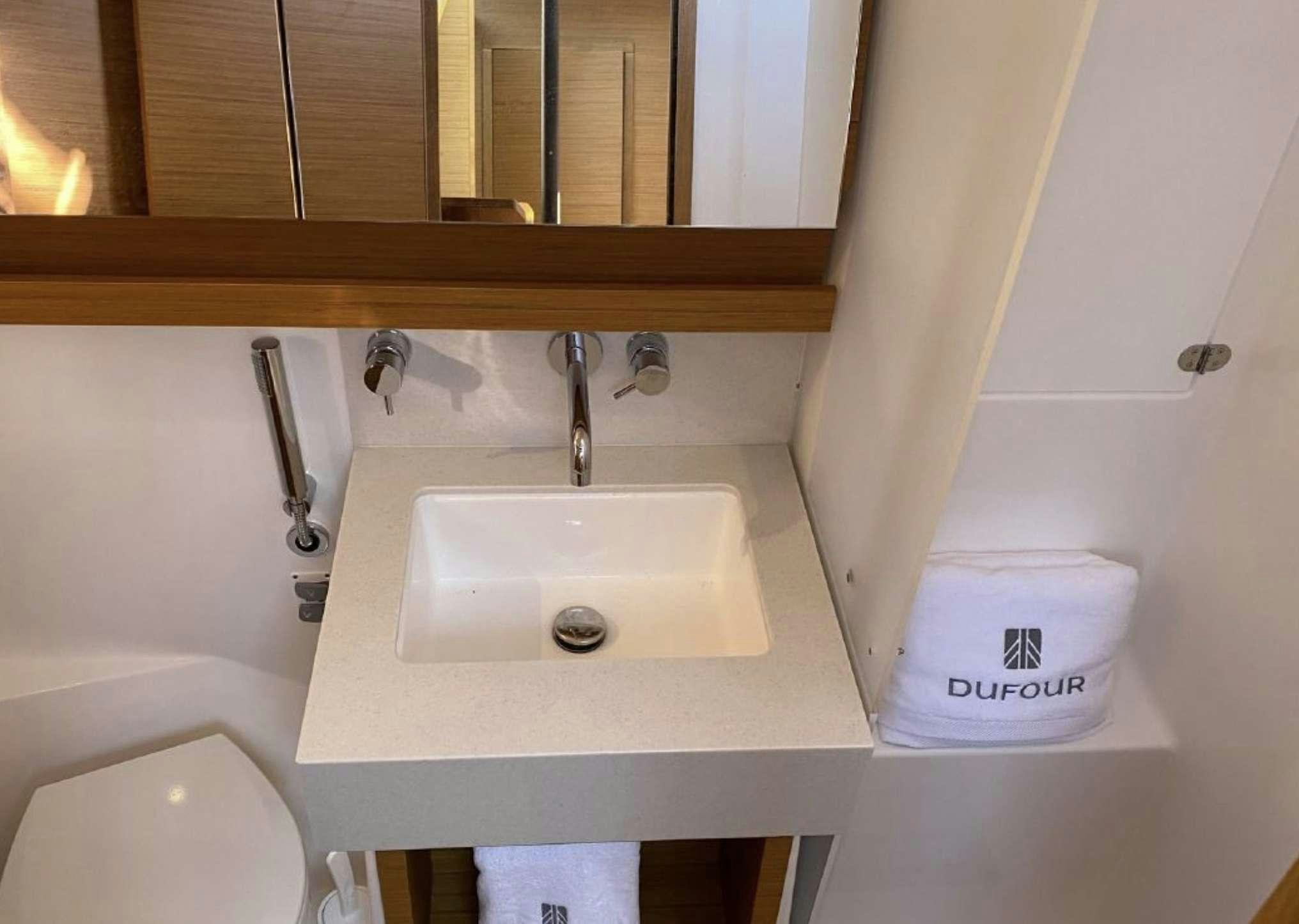 a bathroom with a sink and toilet aboard DIMPA Yacht for Charter
