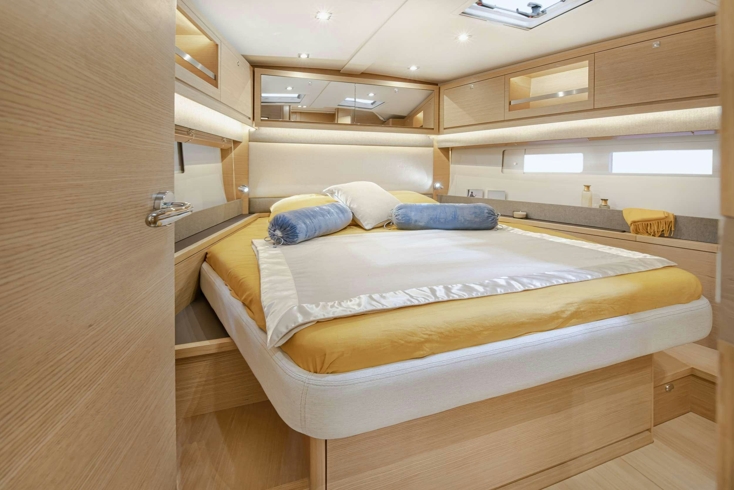 a room with a bed and a desk aboard DIMPA Yacht for Charter