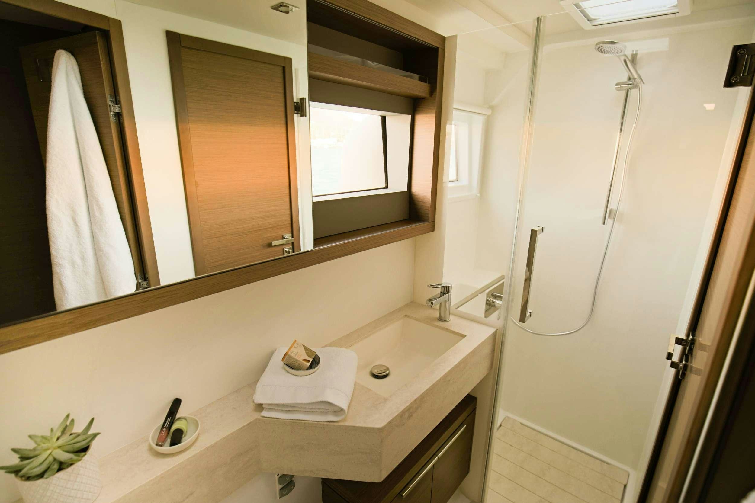 a bathroom with a sink and mirror aboard ANDIAMO Yacht for Charter