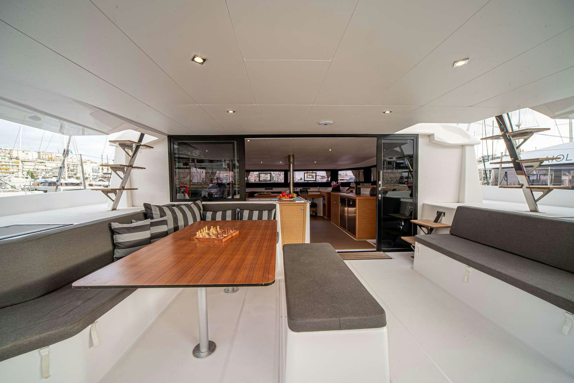 a room with a table and couches aboard MY BLUE HEAVEN Yacht for Charter