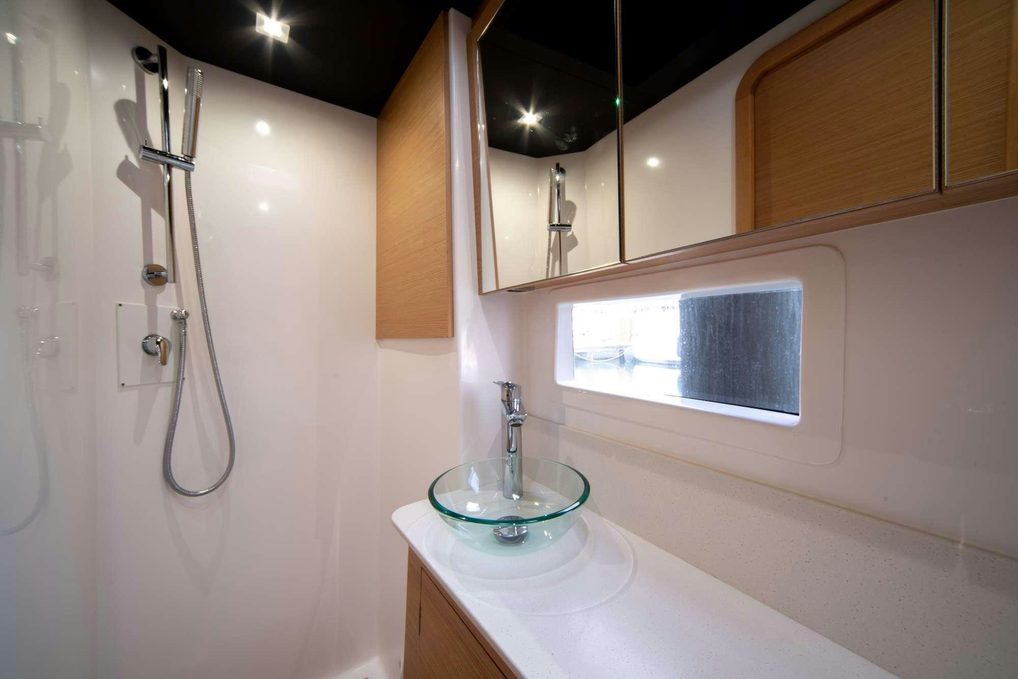 a bathroom with a sink and a mirror aboard MY BLUE HEAVEN Yacht for Charter