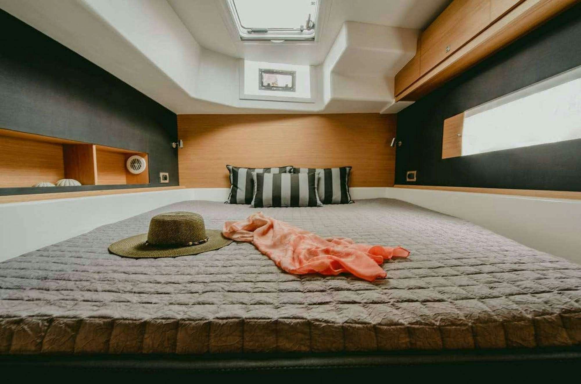 a bed with a hat on it aboard MY BLUE HEAVEN Yacht for Charter
