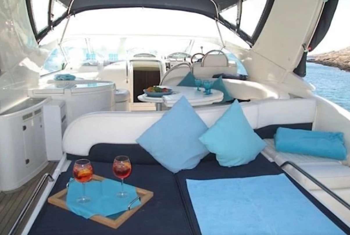 a boat with blue seats aboard JODI Yacht for Charter