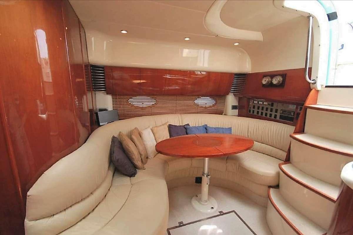 a room with a table and couch aboard JODI Yacht for Charter