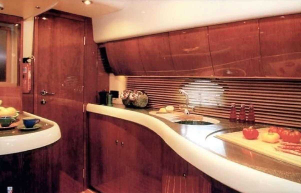 a kitchen with wooden cabinets aboard JODI Yacht for Charter