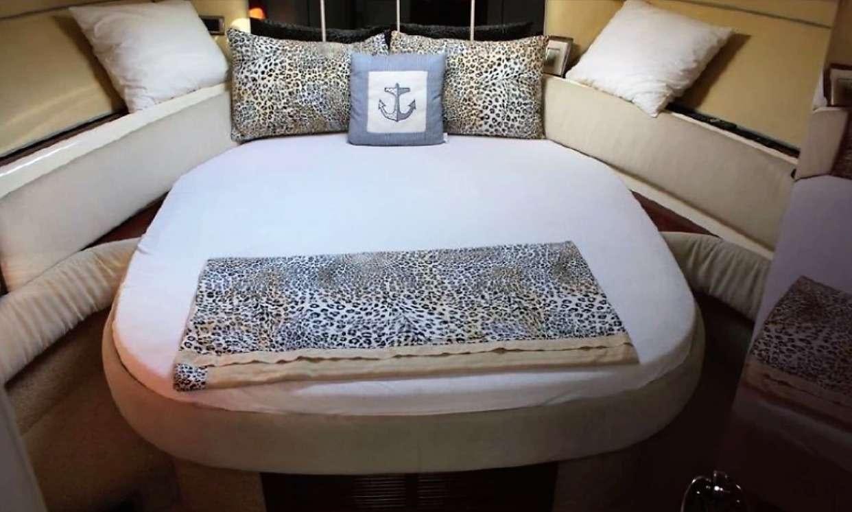 a bed with pillows aboard JODI Yacht for Charter