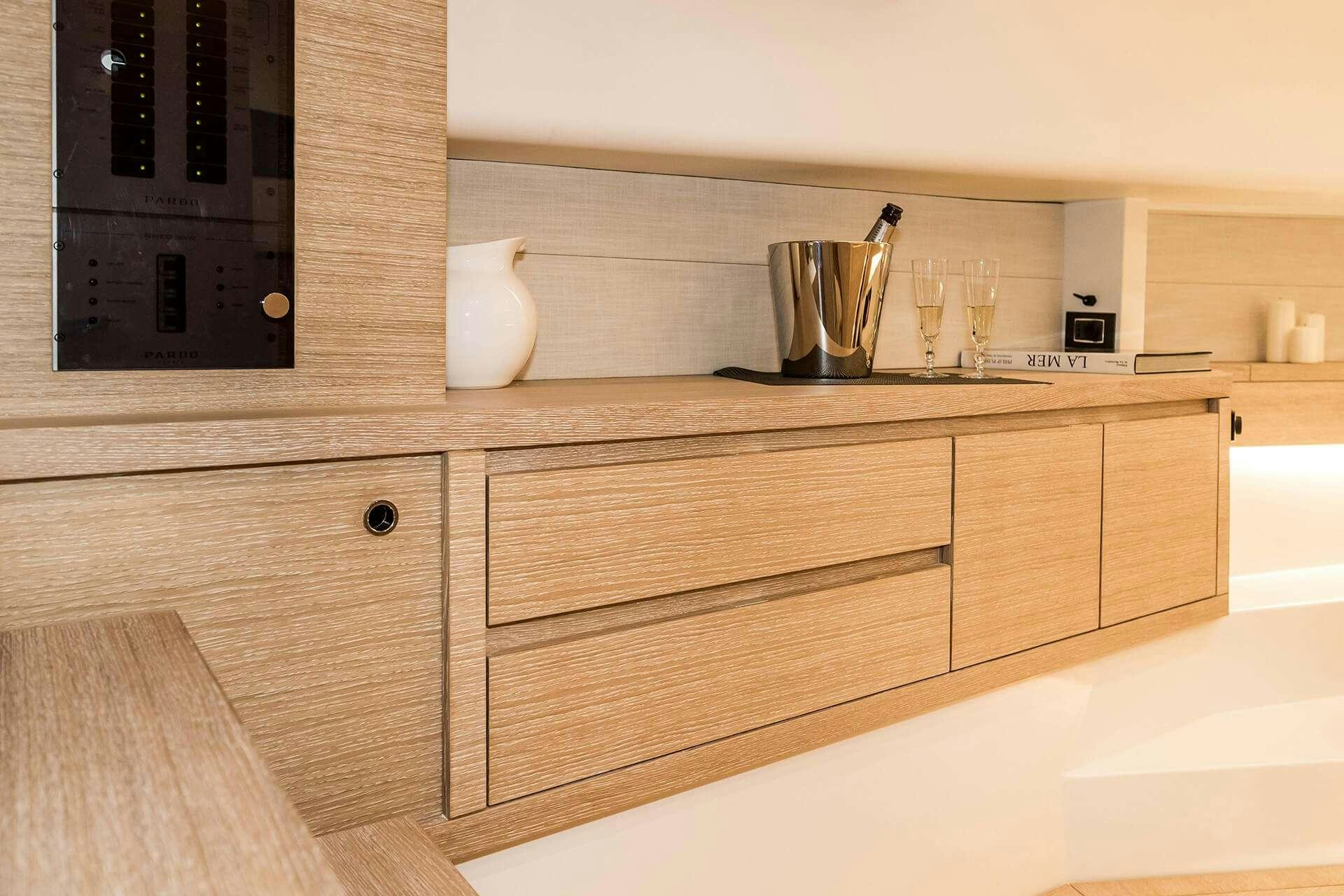 a kitchen with wooden cabinets aboard BABY D Yacht for Charter