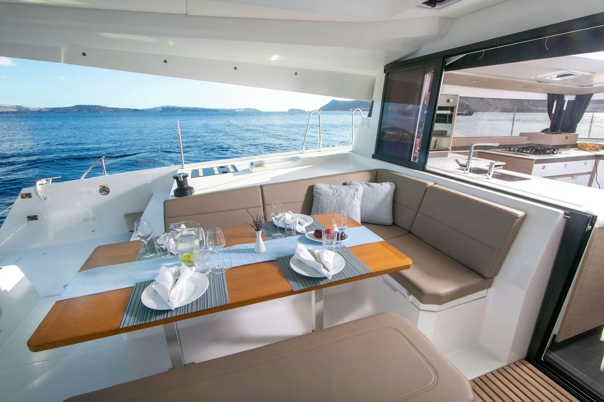 a boat with a table and chairs aboard PAROS Yacht for Charter
