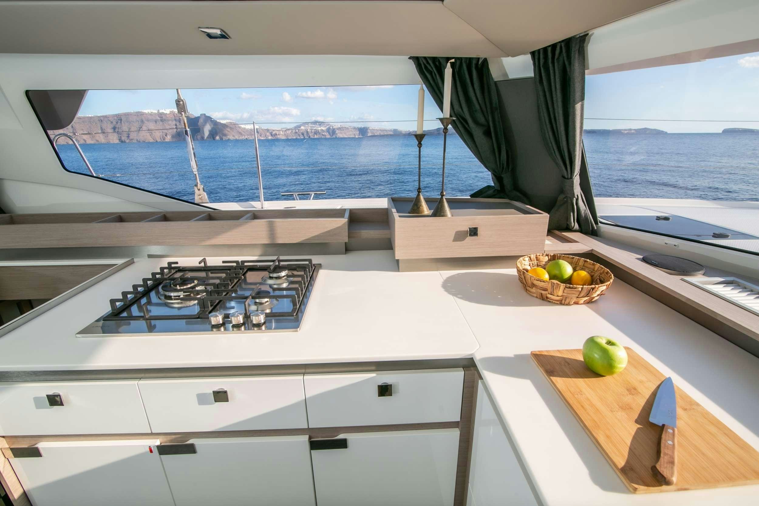 a kitchen with a basket and a basket of fruit on the counter aboard PAROS Yacht for Charter